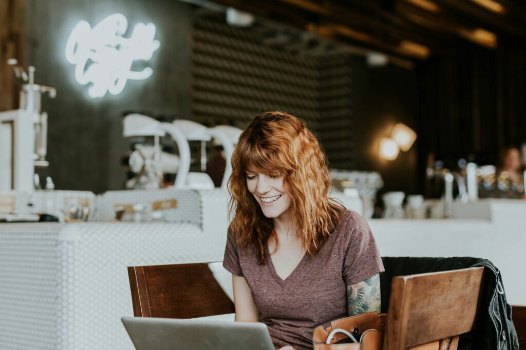 how to build an email list without a website. Woman on laptop in a cafe, building her email list.